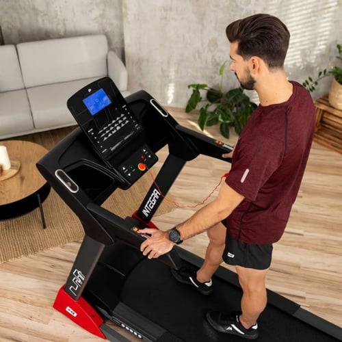 Mann bereitet sich auf Zone 2 Training auf Hop-Sport Laufband vor