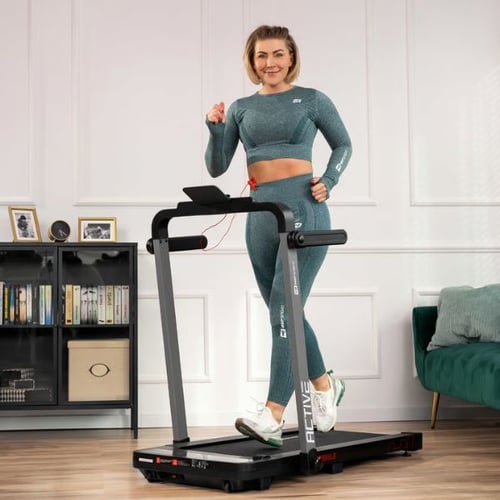 Frau läuft auf einem Hop-Sport Laufband und misst den Puls beim Training
