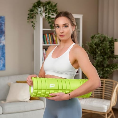 Frau hält grüne Hop-Sport Faszienrolle