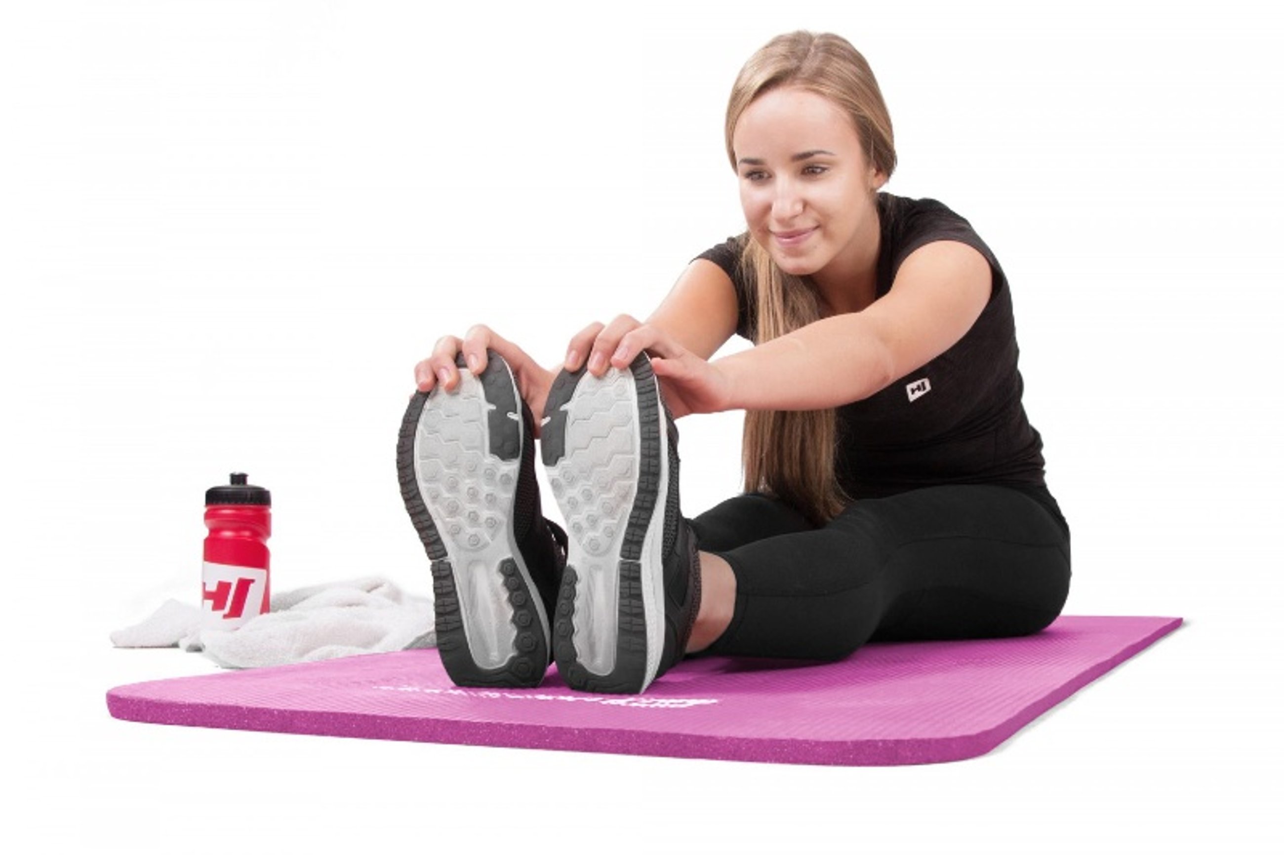 Eine Frau trainiert Yoga auf der Gymnastikmatte von Hop-Sport